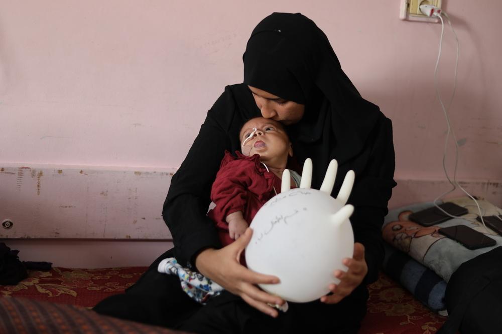Janna Mtair, âgée de trois mois, sur les genoux de sa mère, Reem Ahmad, à l’hôpital Nasser, après être née avec le syndrome de Beckwith-Wiedemann. Gaza, Palestine. Novembre, 2025 © Nour Alsaqqa/ MSF